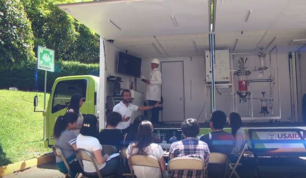 Students listening to the explanation of biodiesel generation in the "Steam Truck"